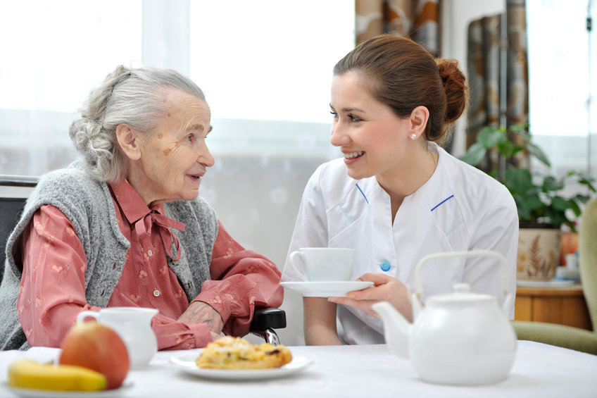 Senior woman eats lunch at retirement home